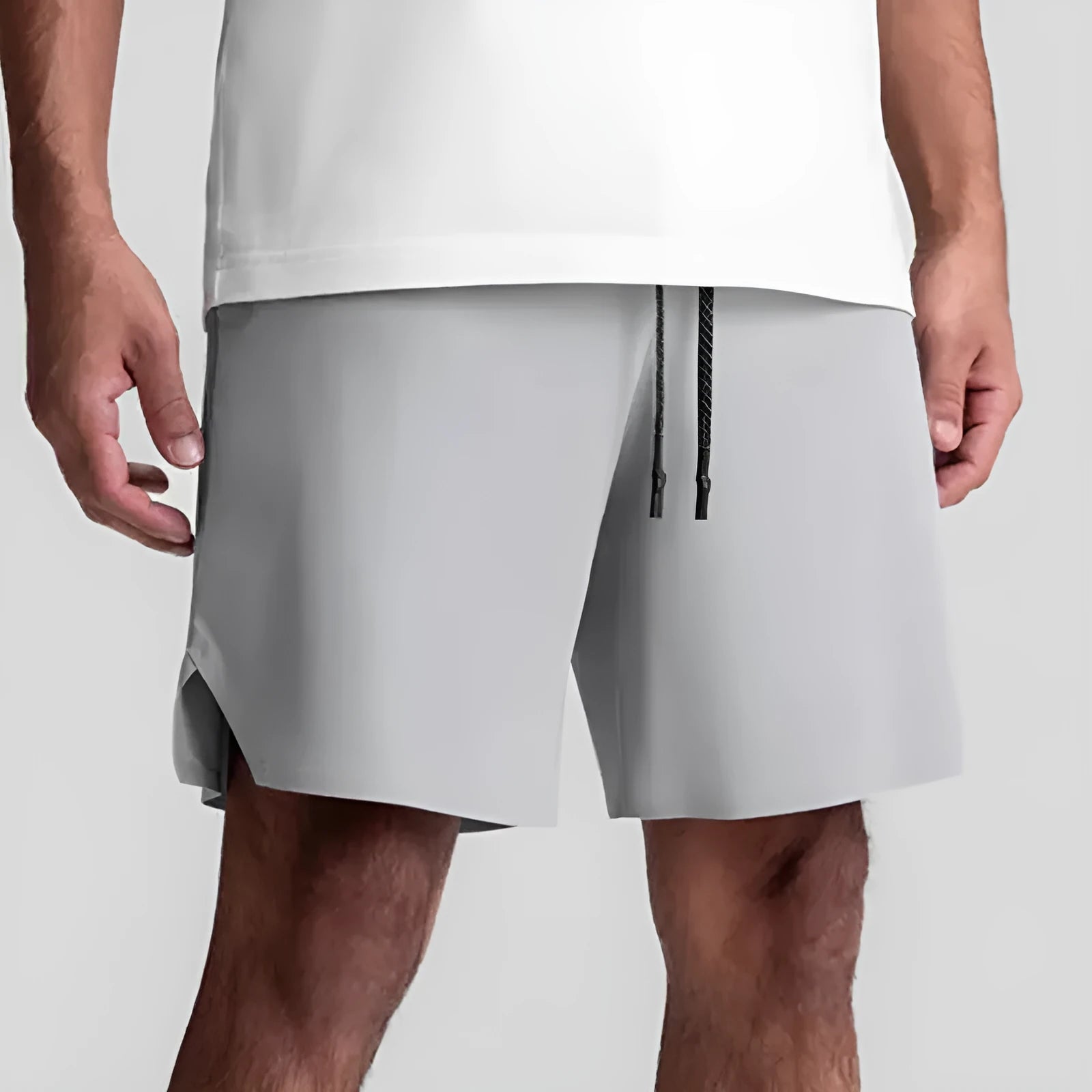 Men's grey seamless sports shorts with knee-length straight leg design and quick-dry fabric
