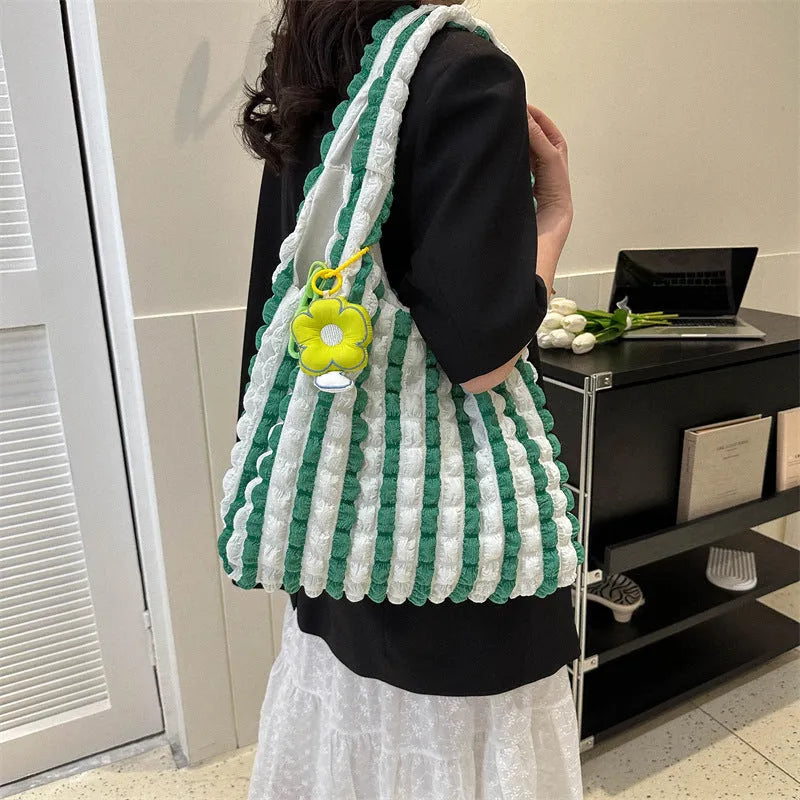 Soft square polyester shoulder bag with pleated bubble texture and an optional pendant, shown in multiple colours.