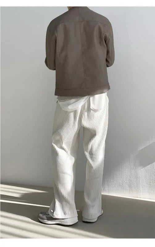 Men's loose corduroy casual pants in solid colour with high waist, drawstring no-fly closure and ankle-tied cuffs.