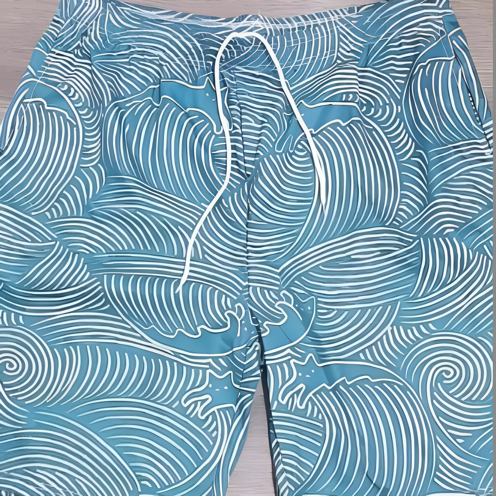 Man wearing loose blue 3D digitally printed straight-leg sports shorts on a summer day.