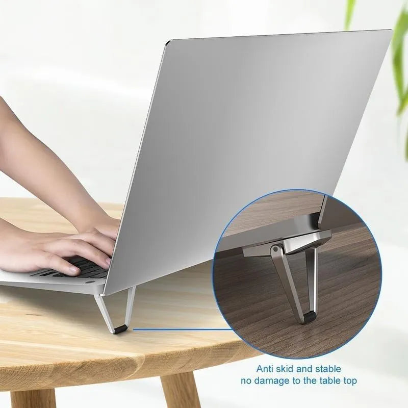 Compact aluminium alloy computer bracket folded to 4.8cm with adhesive backing for laptop support