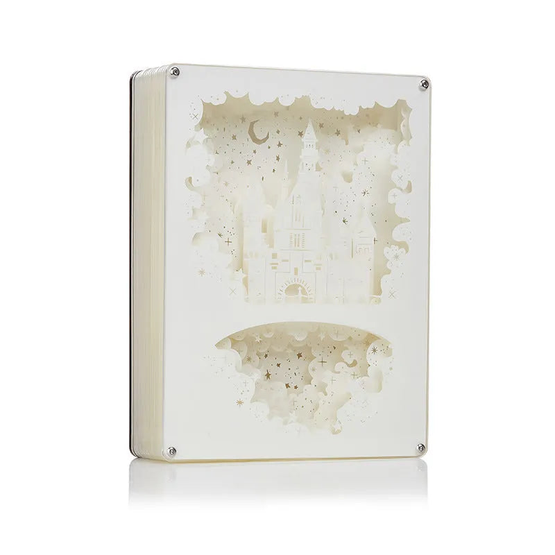 Modern white USB bedside night light with a carved plastic shade, sitting on a wooden table next to its remote control.