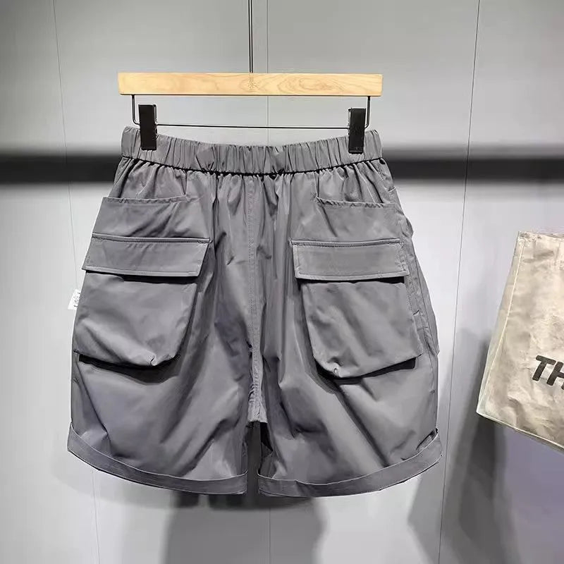 Men's black workwear shorts with loose fit, pockets, and non-ironing fabric, sized for waists up to 115kg
