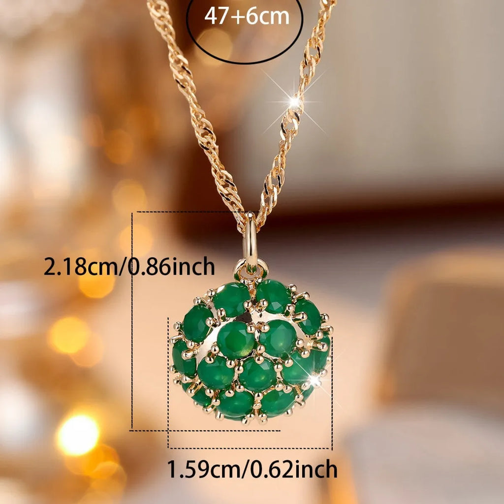 Champagne gold necklace with round emerald pendant and full diamond setting on an adjustable chain.