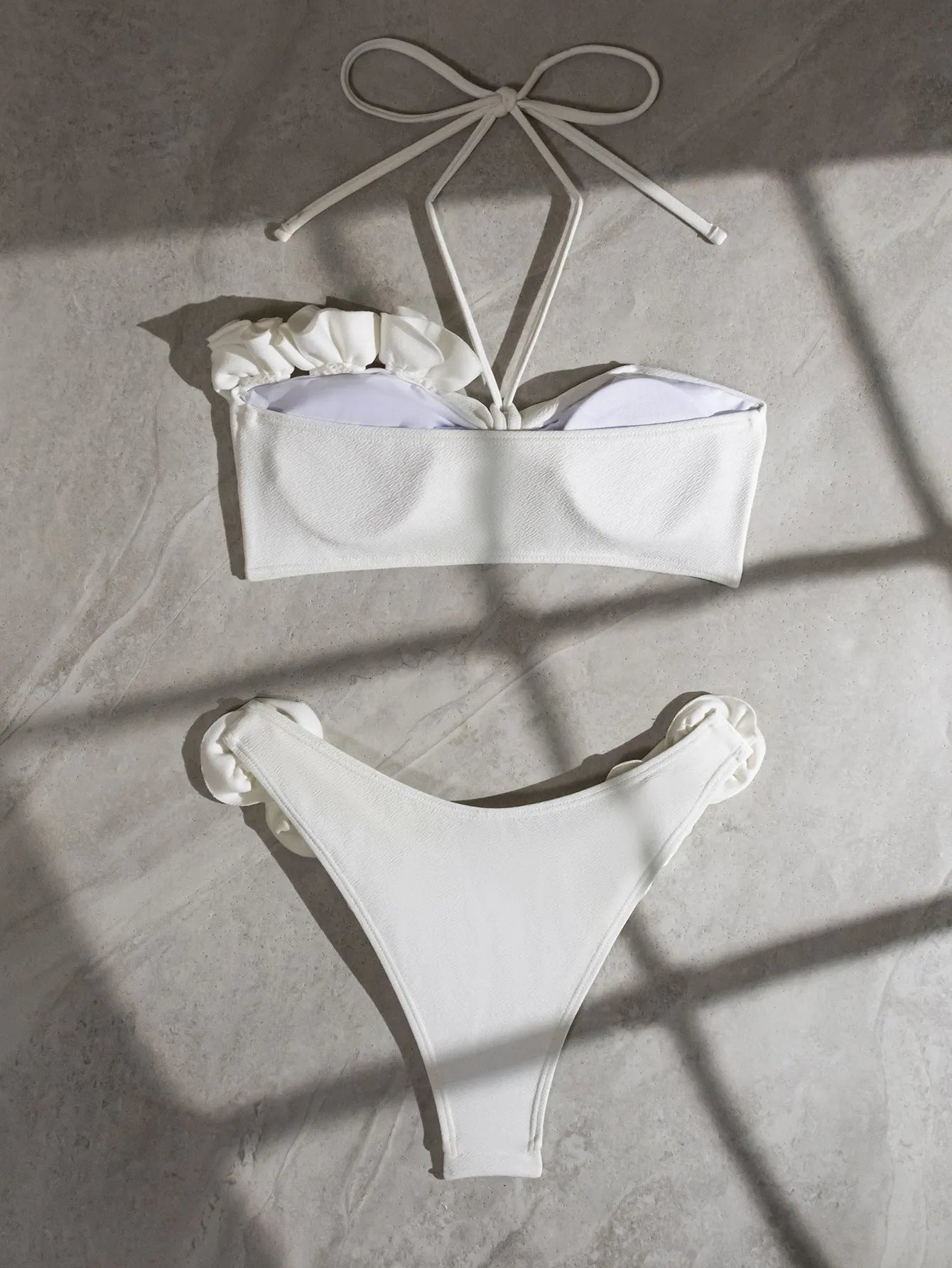 White halter neck bikini with lace-up back and three-dimensional flower detailing for swimming
