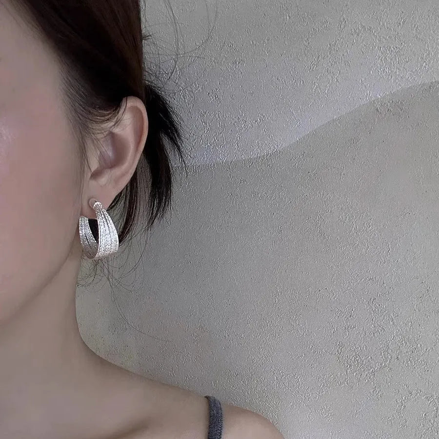 Geometric multi-layer copper earrings with electroplated silver or gold finish, showing stud and clip-on design options