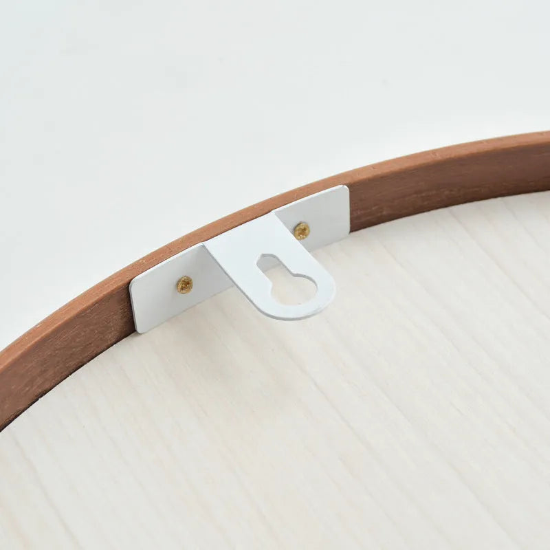Round walnut-coloured solid wood hanging mirror with 30cm diameter and silvered glass