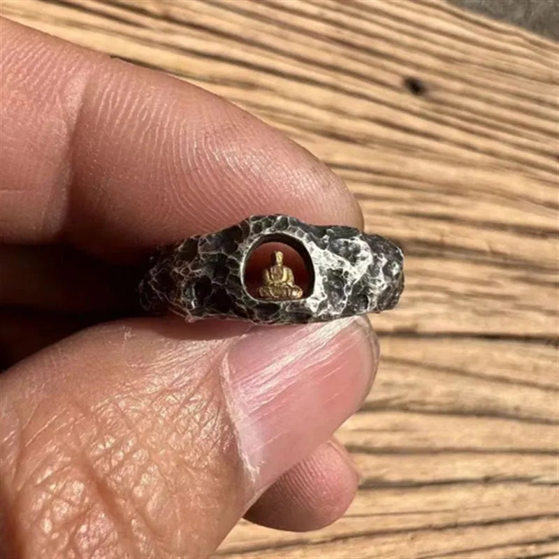 Hand-forged copper ring with rock texture surface and Buddha element, showing hammer marks and matte finish