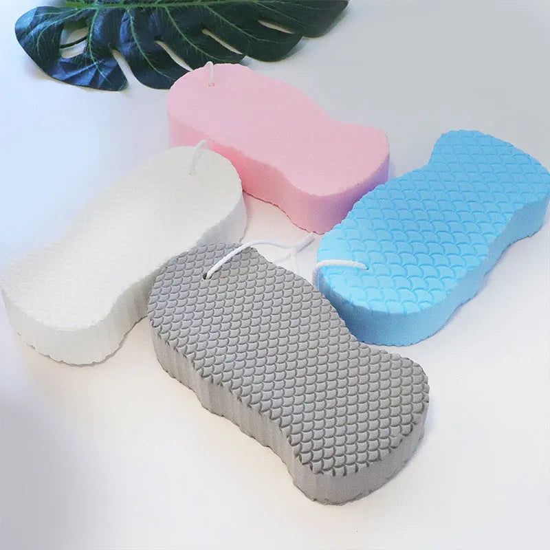 3D body rubbing sponge with fish scale pattern in white, grey, pink, or light blue, showing super-soft texture for gentle exfoliation