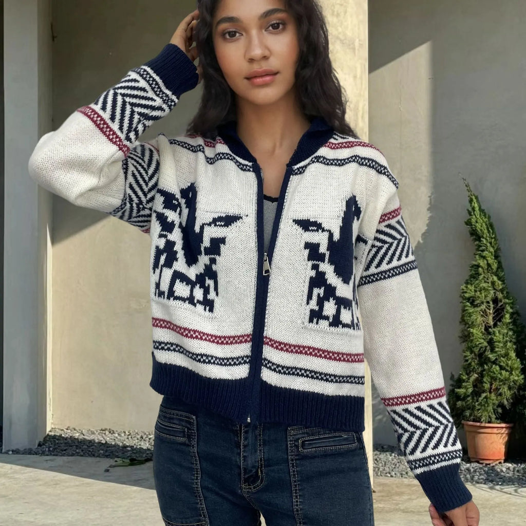 White women's zip cardigan with a contrasting striped jacquard lapel on a hanger.