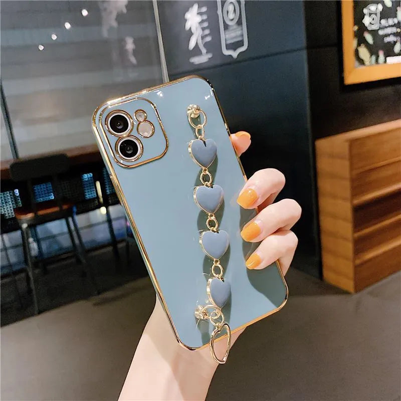Solid colour silicone mobile phone case with an attached wrist strap for Samsung Galaxy smartphones.