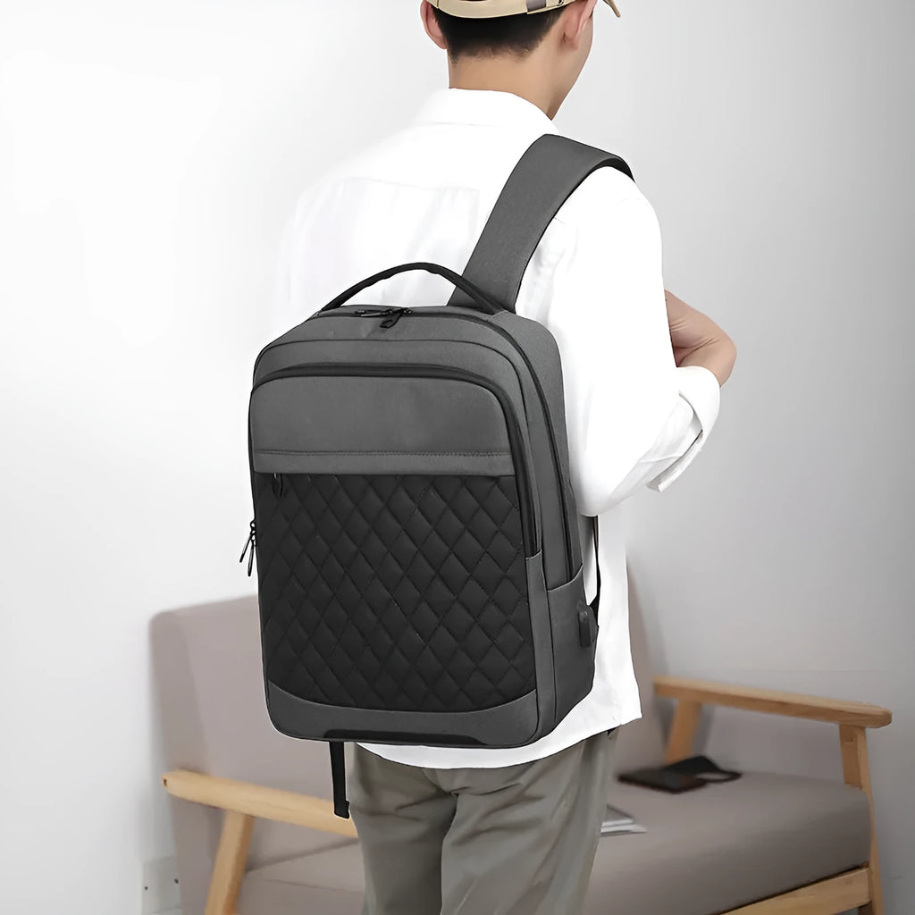 Men's solid colour Oxford cloth travel backpack with diamond mesh panels and curved shoulder straps.