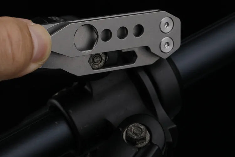 Titanium multi-function crowbar tool with screwdriver tip and bottle opener, shown in stone wash and gun grey finishes.