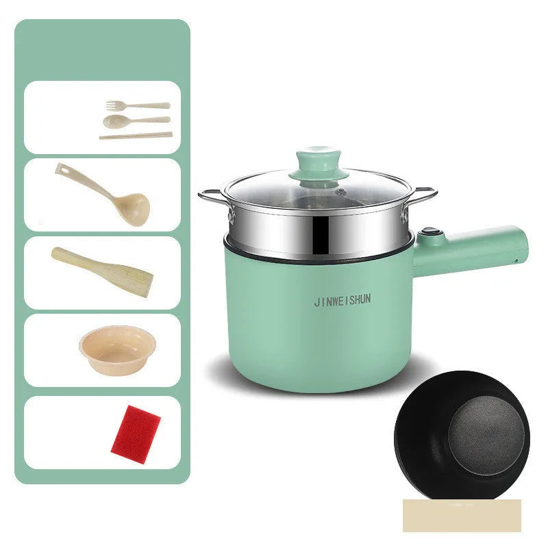 White and green mini electric hot pot cooker with stainless steel body and cooking accessories on a kitchen counter.