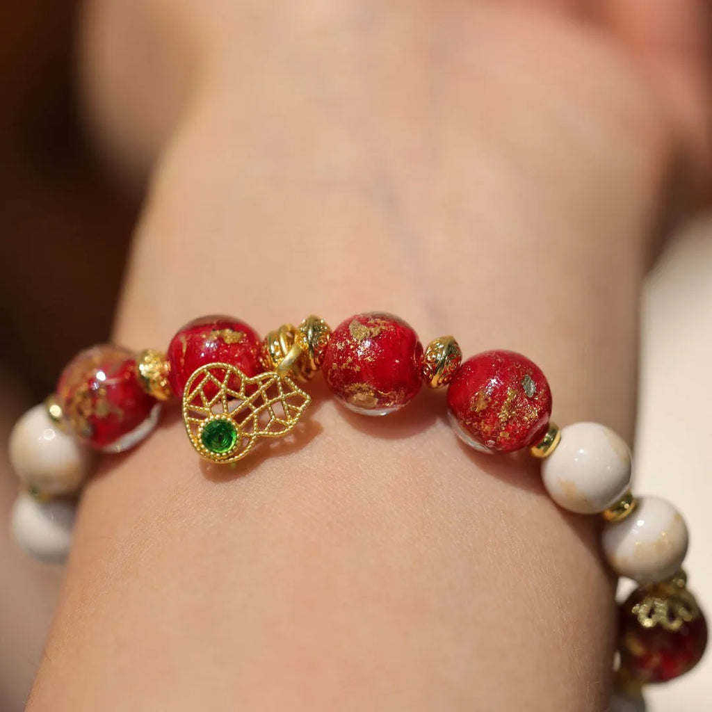 Gold foil coloured glaze ethnic bracelet with geometric design and God of Wealth pearl or porcelain hanging gourd