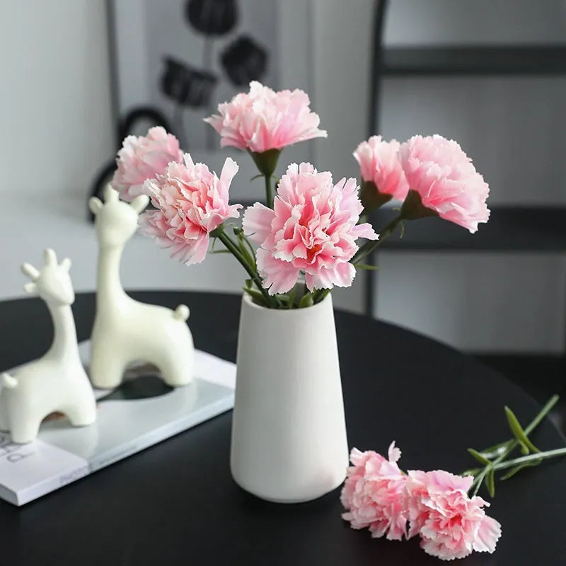 Artificial carnation flower with silk petals on soft rubber base in four colour options