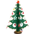 Hand-painted wooden Christmas tree decoration in red or green, 36cm tall, on a desktop