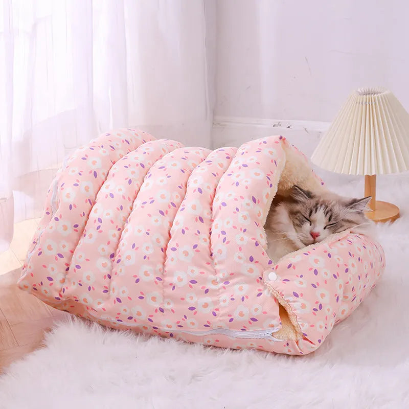 Closed cloth cat bed with removable cushion in a pink small flower pattern.