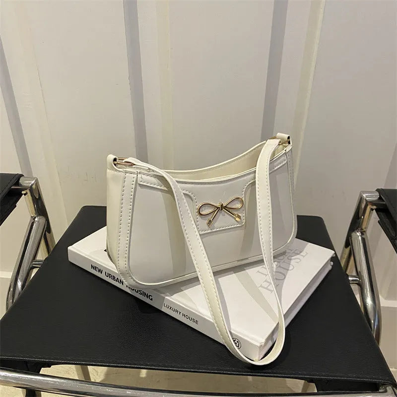 Horizontal square PU leather shoulder bag with a bow decoration, shown in multiple colours.