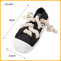 Yellow flexible dog chew toy shaped like slipper with textured surface for dental cleaning