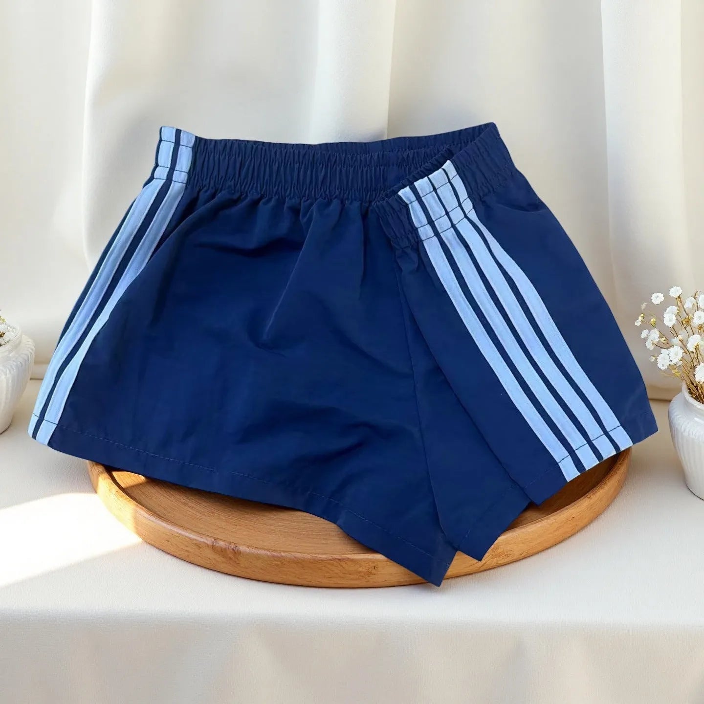 Navy blue men's high-waist nylon sports shorts on a white background