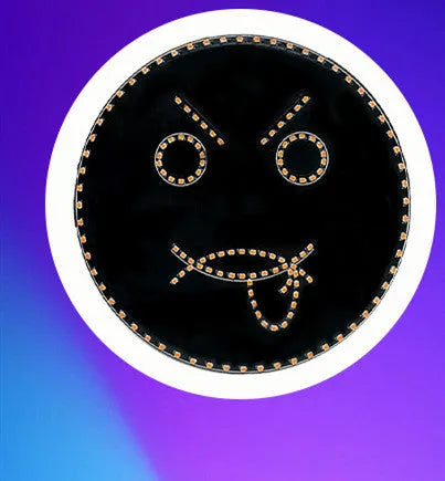 Black car rear window LED expression light showing smiley face pattern with orange illumination