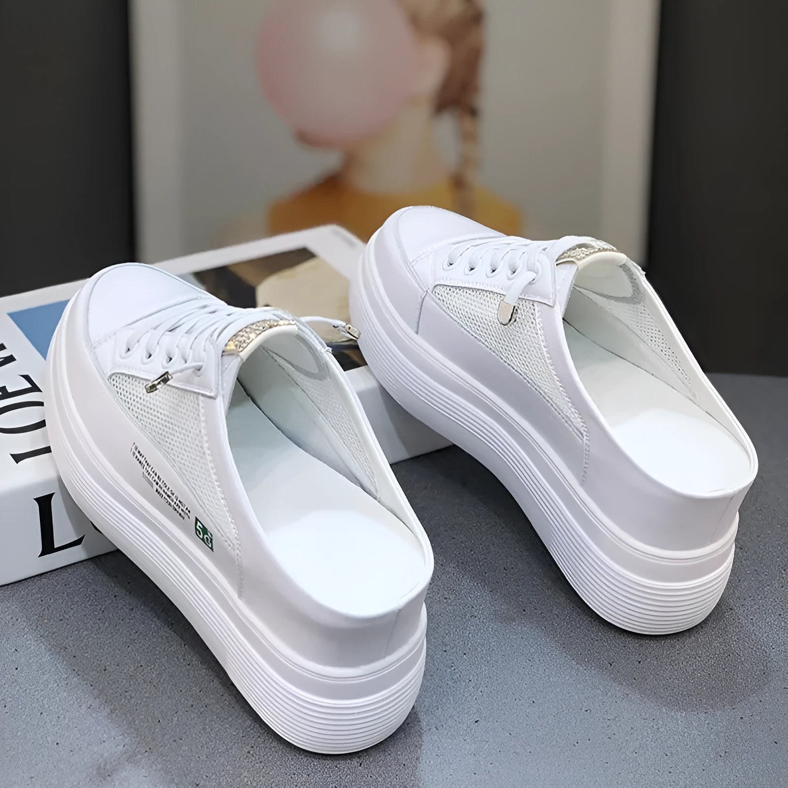 White women's platform shoes with mesh detail and a round toe on a rubber sole.