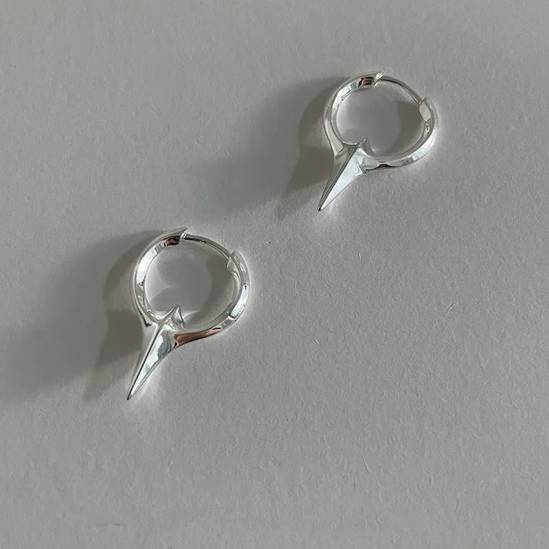 Geometric star ear clips with white gold electroplating on copper, showing secure clip mechanism and detailed star shape