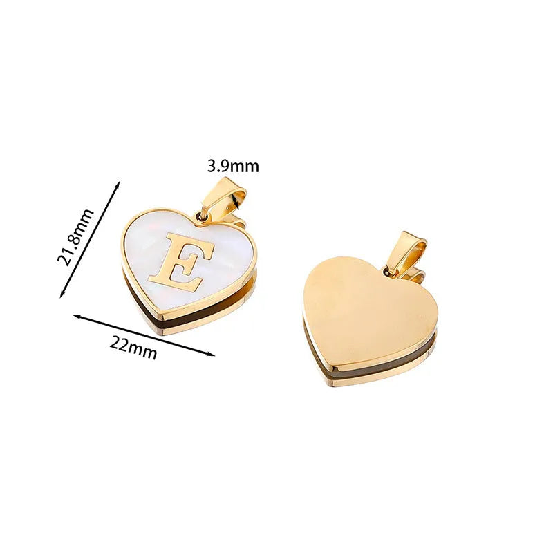 Gold-plated heart-shaped white shell initial necklace on a model, showing the adjustable clavicle chain.
