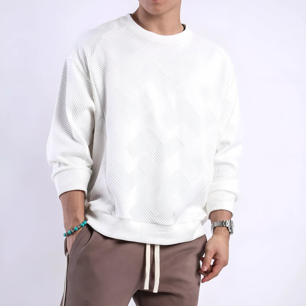 Men's solid colour long-sleeved sweater in twill jacquard fabric, shown in a loose fit with a round neck.