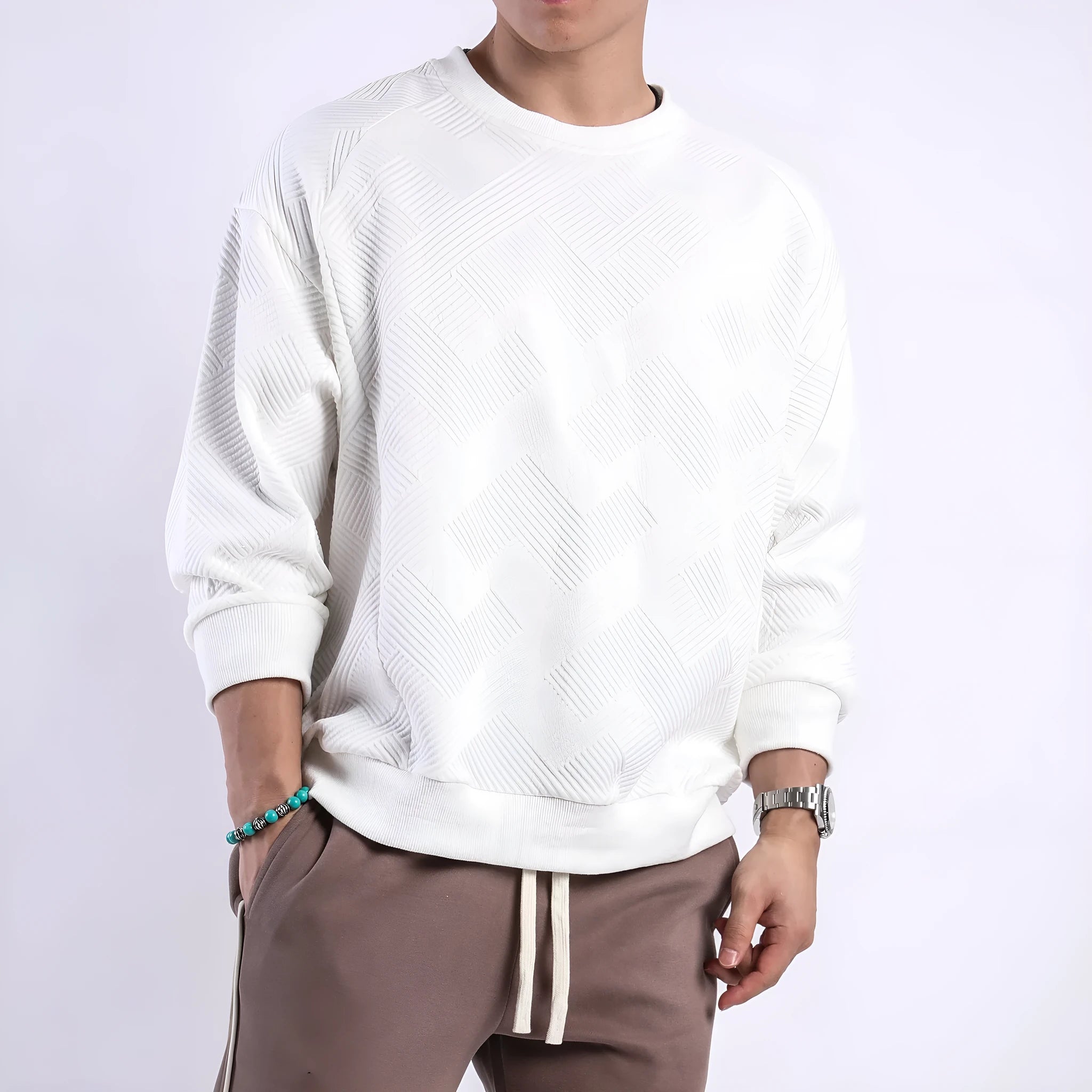 Men's solid colour long-sleeved sweater in twill jacquard fabric, shown in a loose fit with a round neck.
