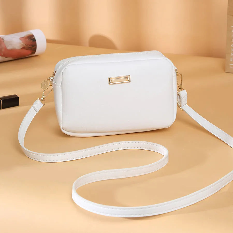 Women's solid colour PU shoulder bag with three-dimensional pocket in orange red, showing horizontal square shape and urban simplicity style