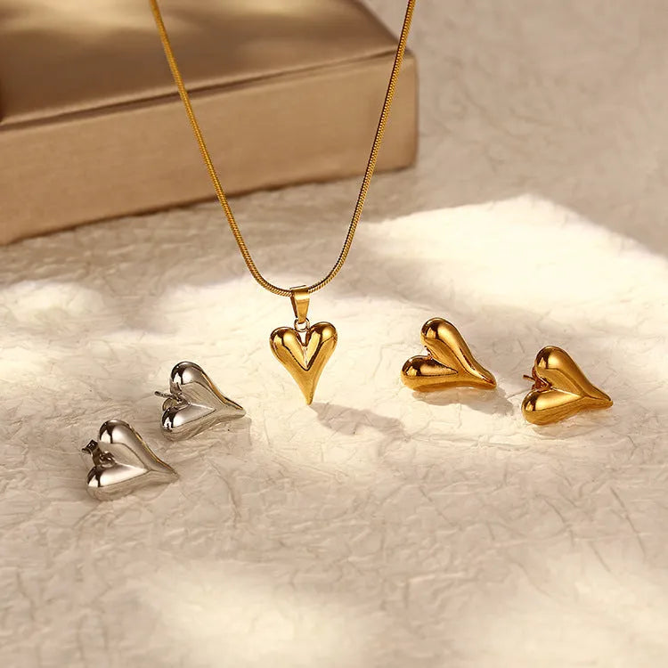 Heart-shaped stainless steel necklace with snake bone chain and matching earrings in gold or steel tone