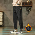 Men's tapered corduroy trousers in army green showing straight-leg street fashion style