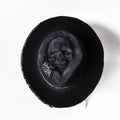 Handmade wool felt skull hat with conical crown showing integrated skull pattern design