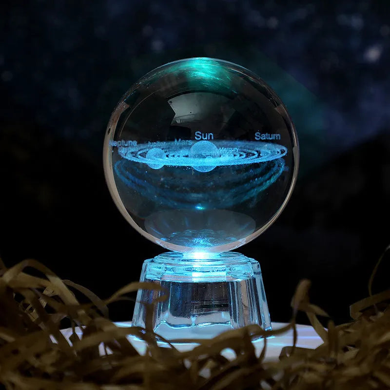 Transparent 6cm white crystal ball ornament with inner carving patterns illuminated by small night lamp on tabletop