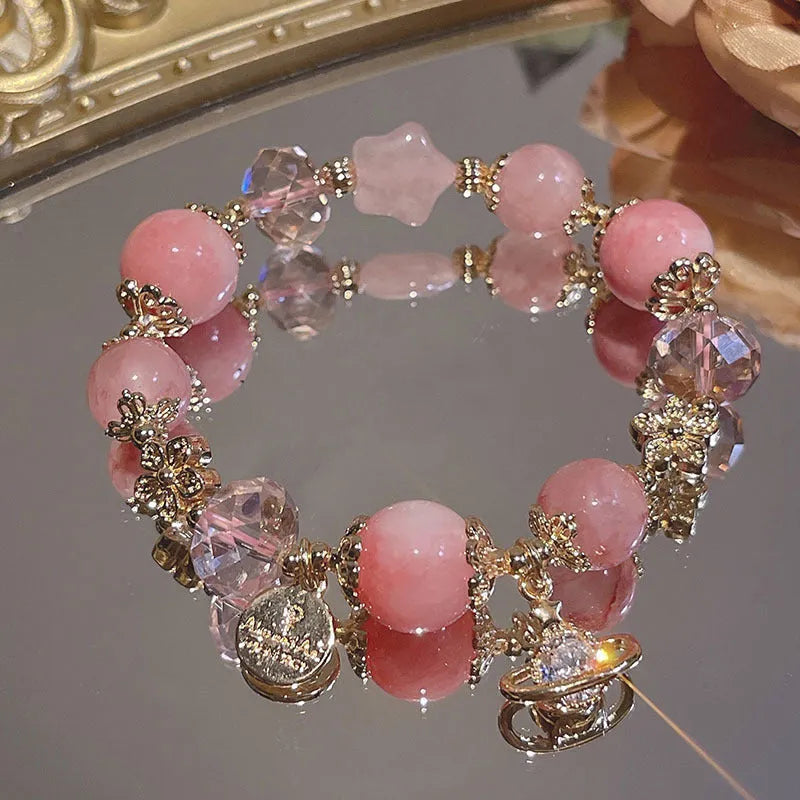 Galaxy-coloured women's alloy bracelet with snowflake pendant and bow charm.