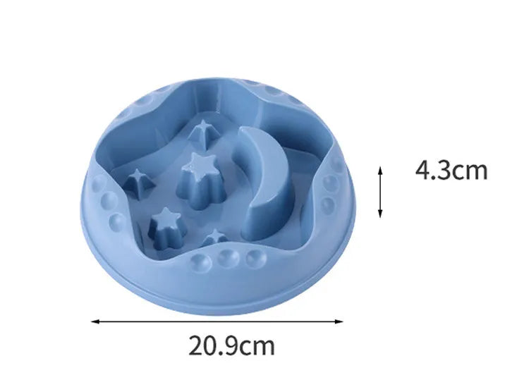 Moon star wings design slow feed dog bowl in blue, shown on a floor.
