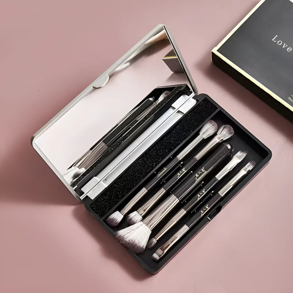 Portable makeup brush set with mirror showing artificial fibre brush heads and silver/gold plastic handles