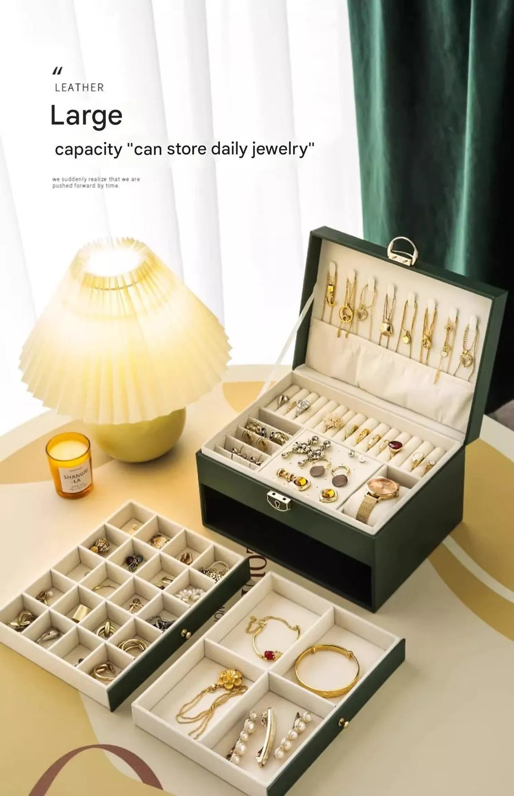 Leather jewellery storage box with three drawers open, showing storage for necklaces, earrings, and bracelets.