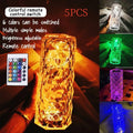 Clear acrylic rose-shaped LED table lamp with touch controls on a wooden surface.