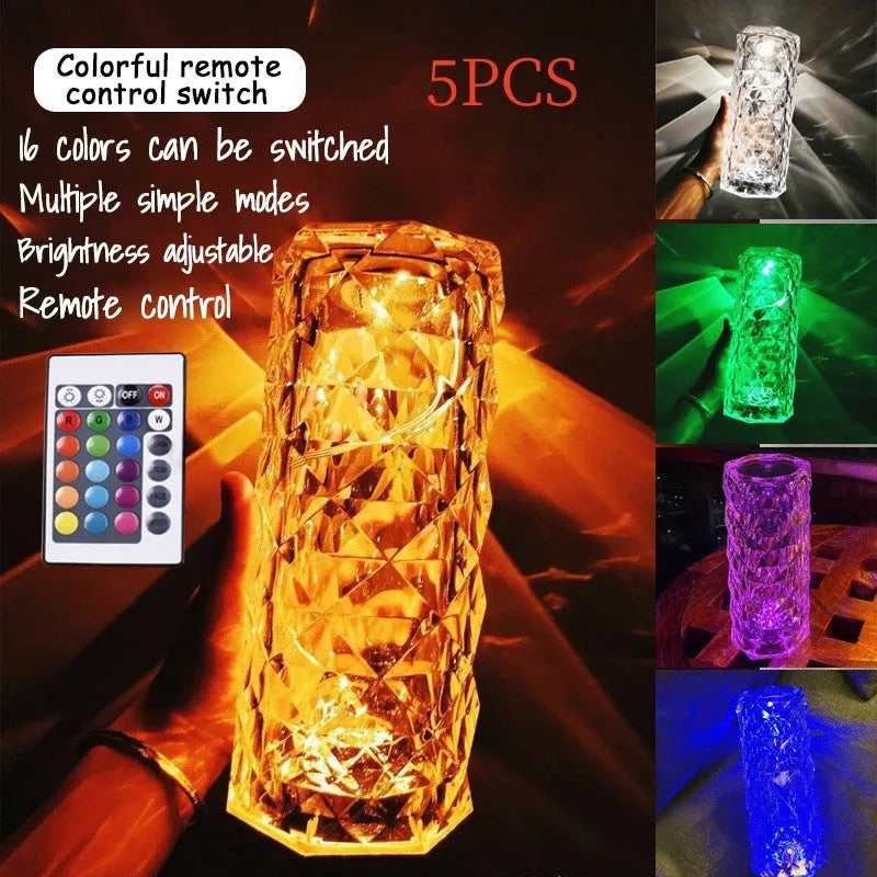 Clear acrylic rose-shaped LED table lamp with touch controls on a wooden surface.