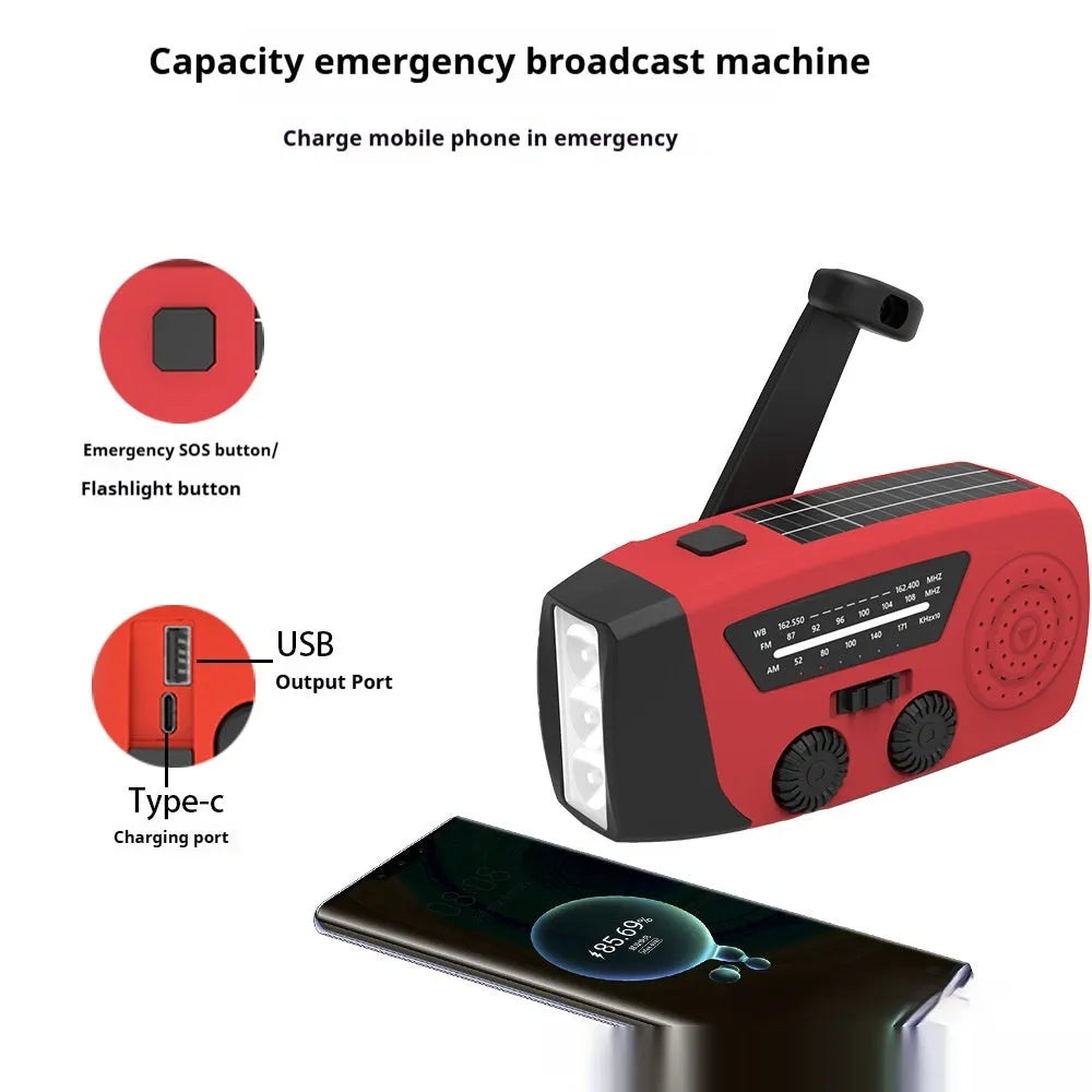 Red rechargeable handheld torch and radio with wrist strap and USB charging cable.