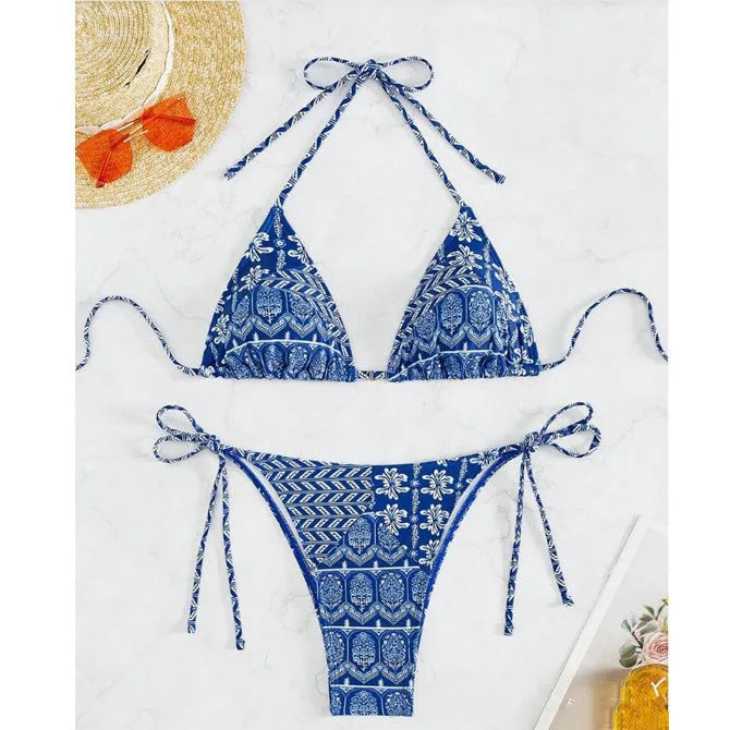 Women's green bandage-style split bikini swimsuit with stitching detail on a mannequin.