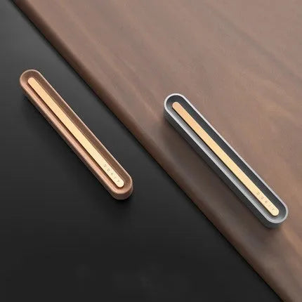 Long strip car aromatherapy ornament in walnut colour mounted on a car air vent