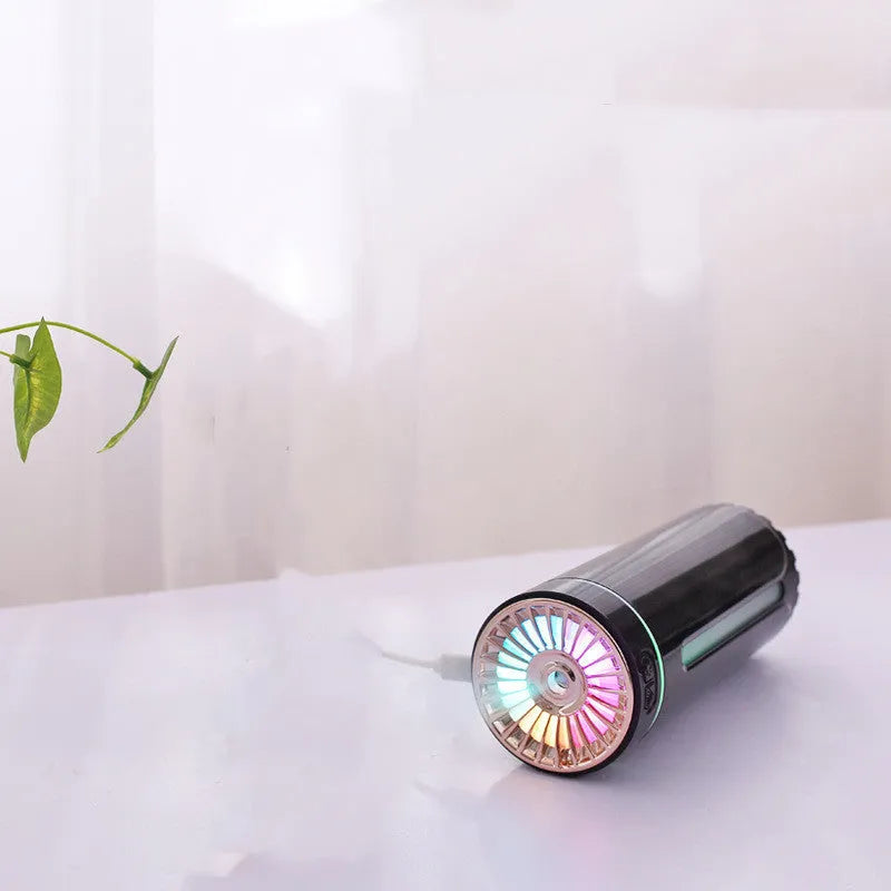 Black portable USB rechargeable humidifier with colourful LED lights on a car cup holder.