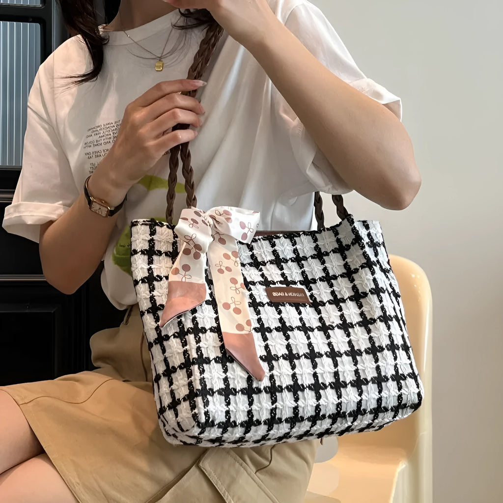 Black woolen shoulder bag with horizontal square shape showing internal organisation compartments