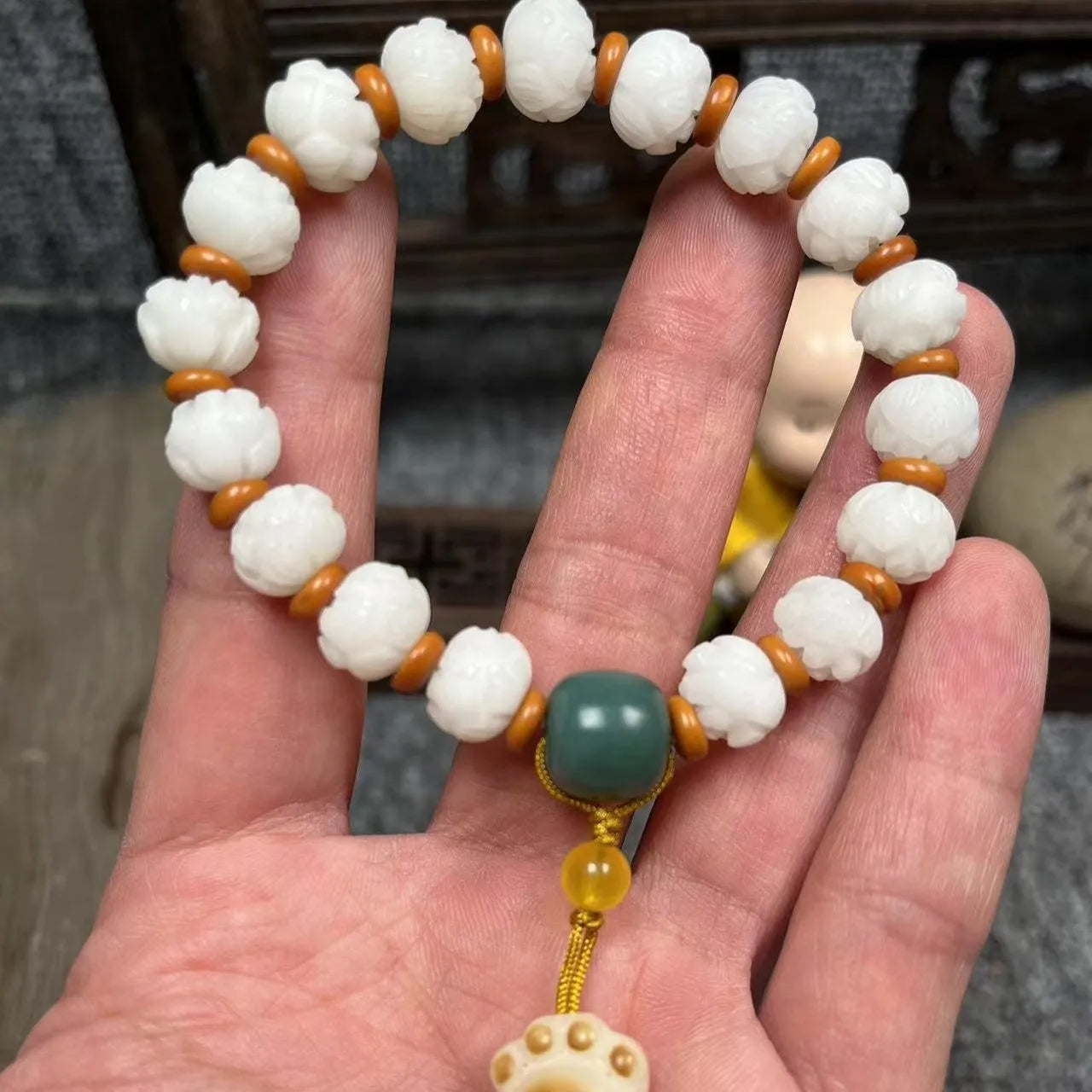 Hand-carved Bodhi root bracelet with White Jade beads, lotus carvings, and a cat's paw pendant.