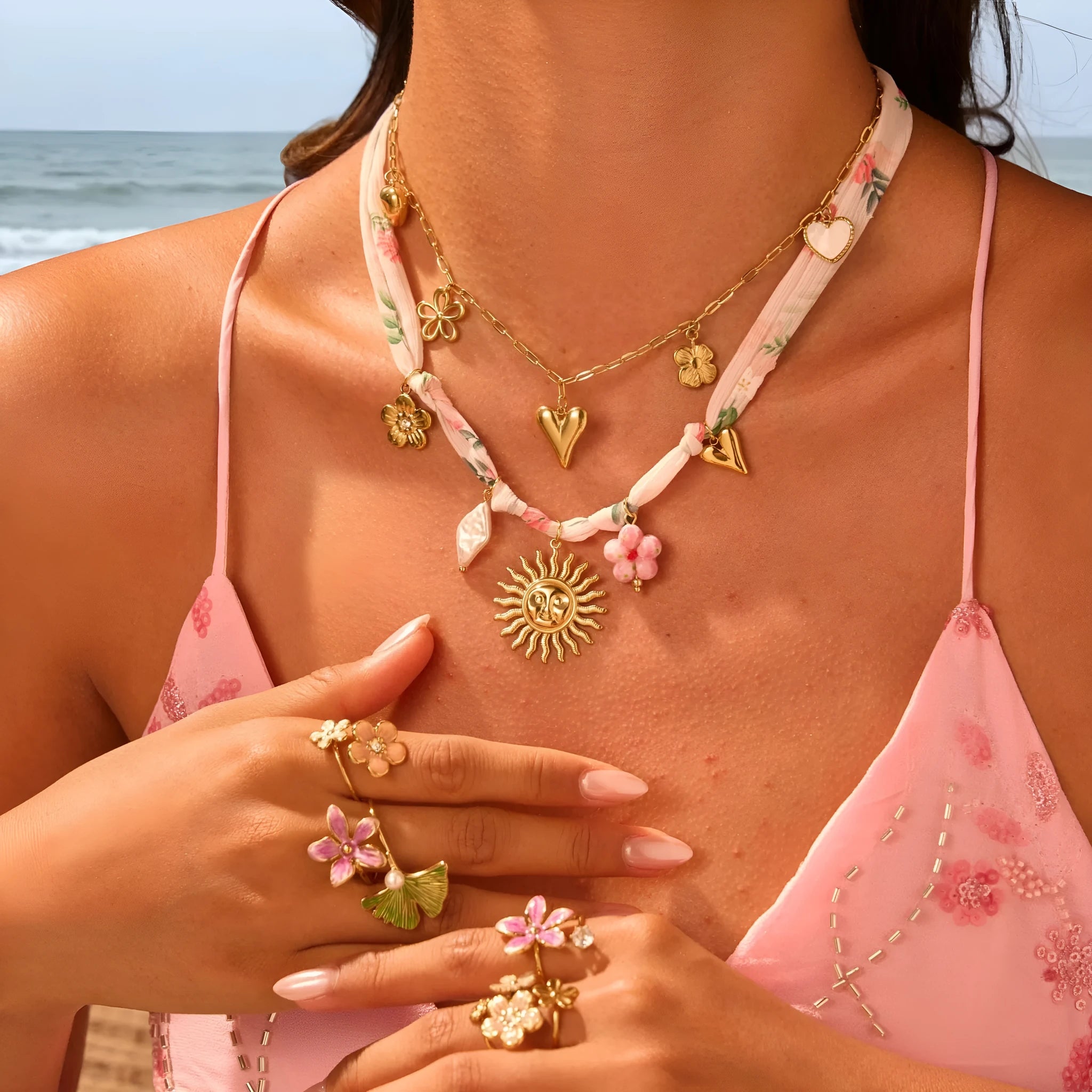 Stainless steel necklace with a geometric sun pendant on a regular chain, showing heart and ribbon sun style options.