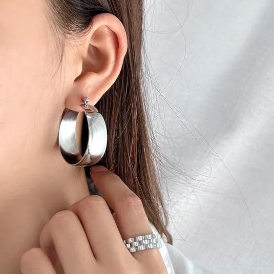 Widened curved stainless steel earrings in gold or steel colour, available in 25mm or 30mm sizes